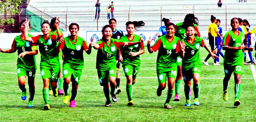 Players of Bangladesh Under-15 women football team celebrate after beating India Under-15 football team in the South Asian Football Federation (SAFF) Under-15 Women's Championship match at the Bir Shrestha Shaheed Sepoy Mohammad Mostafa Kamal Stadium in