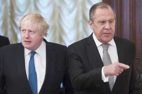 Russian Foreign Minister Sergey Lavrov, right, and British Foreign Secretary Boris Johnson enter a hall for their talks in Moscow, Russia on Friday.
