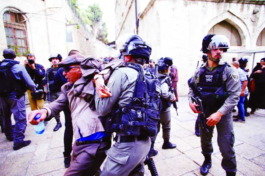 Israeli security personnel clash with a Palestinian protester during a demonstration in Jerusalem's old city, as Palestinians call for a "Day of Rage" in response to U.S. President Donald Trump's recognition of Jerusalem as Israel's capital on Friday