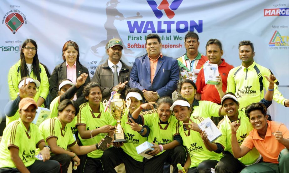 Members of Bangladesh Ansar, the champions of the Walton 1st National Women's Softball Competition with the guest and officials of Bangladesh Baseball-Softball Association pose for a photo session at the Sultana Kamal Women's Sports Complex in the city