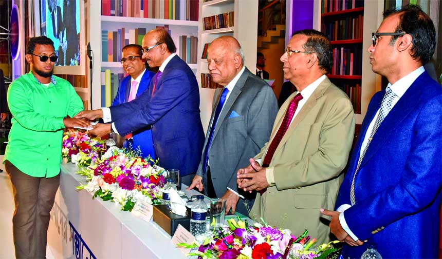 Bangladesh Bank Governor Fazle Kabir, handing over Dutch-Bangla Bank awarded scholarship letters among the students who passed HSCEquivalent Examination in 2017 and studying at Graduation level in different universitiescolleges of the country at Shaheed