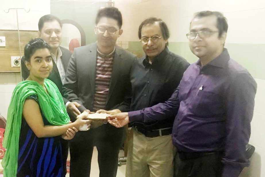 Abbas Uddin Shakil, proprietor of SO Trade recently handed over donation money to Sabrina Mamataj Munni, a cancer patient student of Department of English Literature, Dhaka University. Monzurul Islam, Professor of the Department was present on the occasio