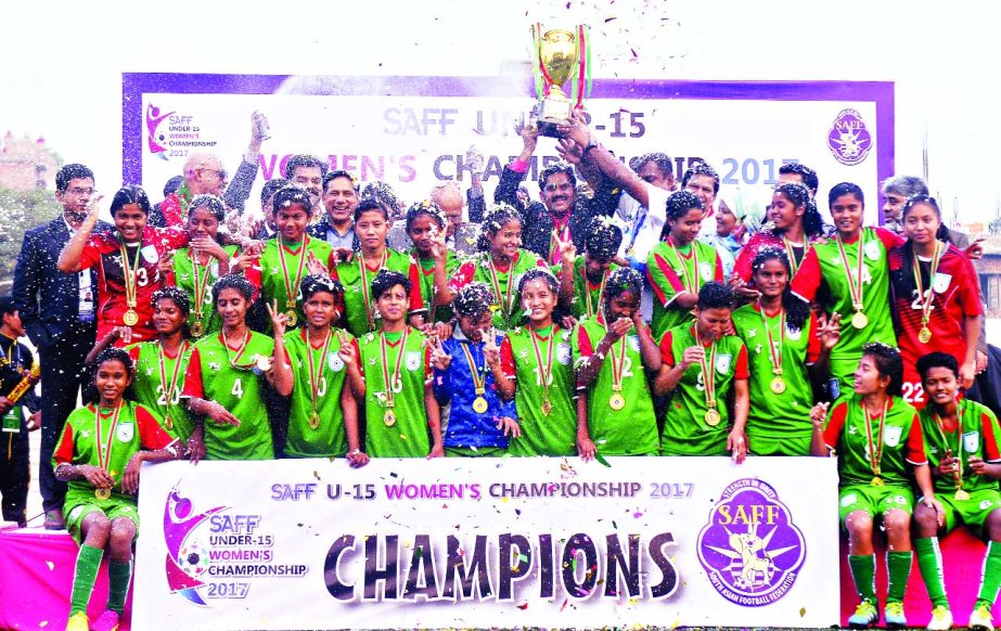 Members of Bangladesh Under-15 National Women's Football team, Champions of the SAFF Women's Under-15 Championship with the Chief Guest Minister for Finance AMA Muhith and the officials of BFF pose for a photo session at the Bir Sreshtha Shaheed Sepoy M