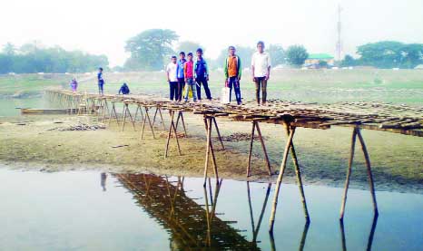 NAOGAON: A pucca bridge is immediately needed over Atrai River at Mohishbathan area in Mohavedpur Upazila as students have to cross the risky two hundred meters long bamboo bridge. This snap was taken yesterday.