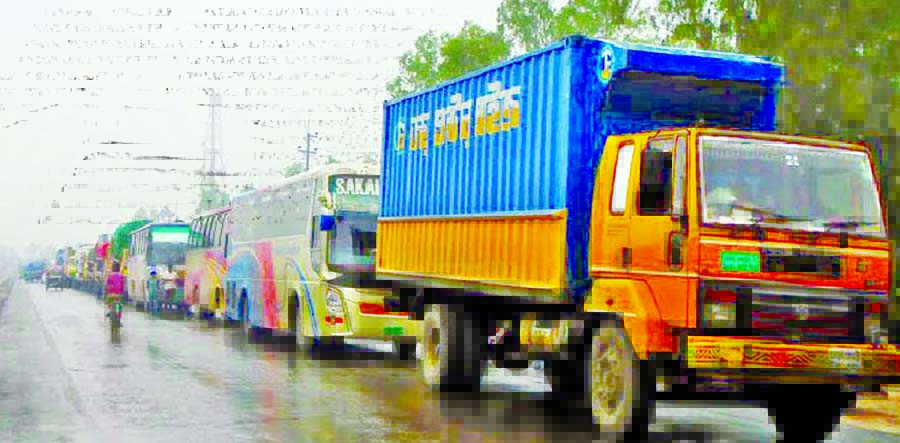 Hundreds of vehicles got stuck in 15 km long queue of traffic tailback created on Dhaka-Tangail Highway since Monday morning due to slow vehicular movement caused by 4-lane construction work on the busy highway.