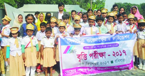 MANIKGANJ: Students and teachers of different educational institutes poses for a photo session after scholarship examination at Shikshaniloy Pre- Cadet School at Shibalaya Upazila organised by Systech Welfare Foundation on Monday.