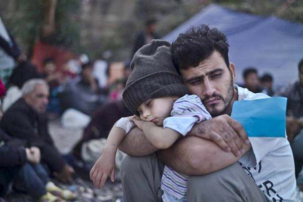 Displaced Syrians, from the eastern city of Deir Ezzor and Raqa who were forced to leave by the war against the Islamic State (IS) group, are seen outside a tent at the Ain Issa camp.