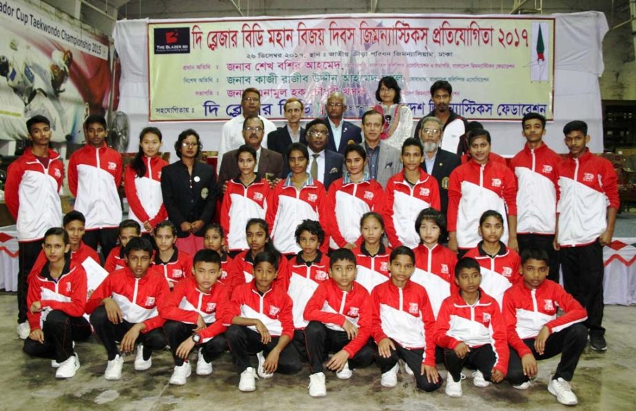 Gymnasts of BKSP, the highest gold medal winners of the Balzer BD Victory Day Gymnastics Competition with the guests and officials of Bangladesh Gymnastics Federation pose for photo at the Gymnasium in the National Sports Council on Tuesday.