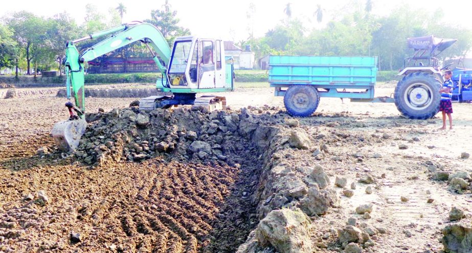 MELANDAH (Jamalpur): Brickfield at Melandah Upazila are taking top soils from the crop lands for use . This picture was taken yesterday.