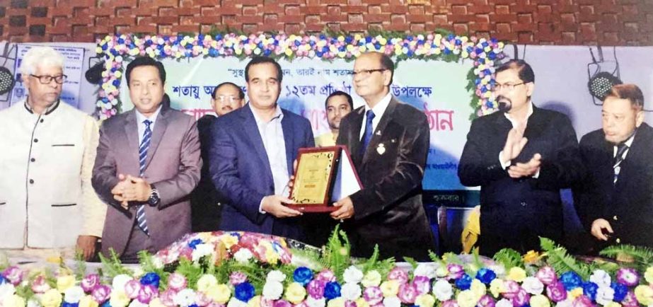 Lions Asit Sen giving crest to the Chief Guest M A Salam, Chairman, Chittagong Zilla Parishad at the 12nd founding anniversary programme of Shtayo Angon Karnophuli in Chittagong recently.