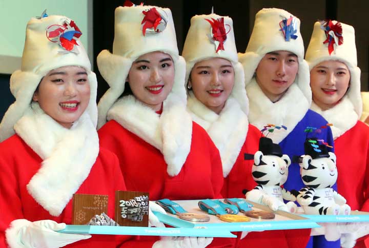 Models wearing the uniforms used in the victory ceremonies for 2018 Pyeongchang Olympic and Paralympic Winter Games attend during an unveiling ceremony in Seoul, South Korea, Wednesday, Dec. 27, 2017. South Korea's Pyeongchang is the host city of the 201