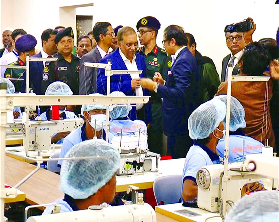 Home Minister Ashaduzzaman Khan Kamal visiting the country's first-ever RMG factory unit set up in N'ganj jail after inaugurating it on Wednesday.