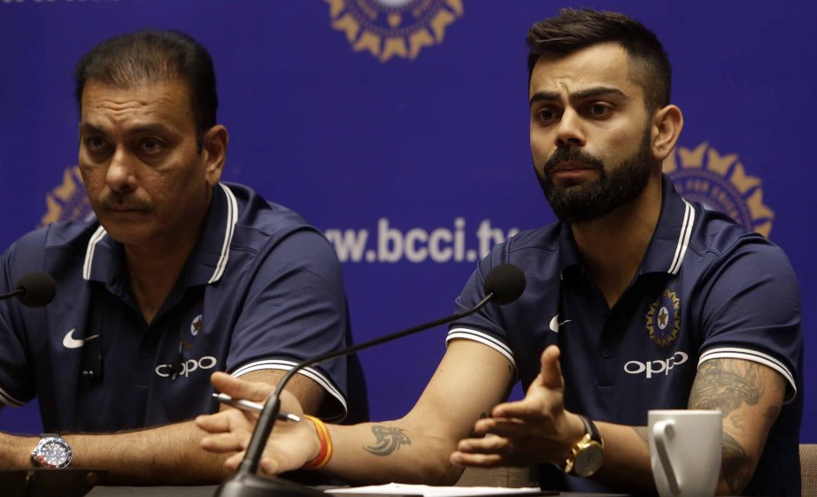 Indian cricket team captain Virat Kohli, right, speaks as head coach Ravi Shastri watches during a press conference ahead of India tour to South Africa, in Mumbai, India on Wednesday. Indian cricket team will play three Test matches, six One Day Internati