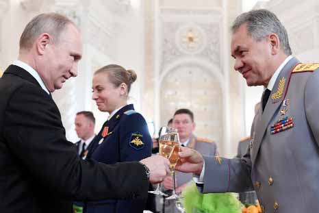Russian President Vladimir Putin, left, toasts with Defense Minister Sergey Shoigu after a ceremony to bestow state awards on military personnel who fought in Syria, at the Kremlin in Moscow on Thursday.