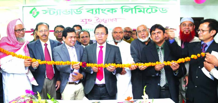 Md. Tariqul Azam, AMD of Standard Bank Limited, inaugurating its 121st branch at Mohadevpur in Naogaon on Tuesday. Haradhan Chandra Das, UNO of Mohadevpur and Mobarok Hossain Parvez, Rajshahi Branch Manager of the bank among others were present.