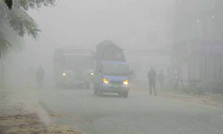 Transports plying with headlight taking risk of life due to heavy thick fog from early morning for several hours. This photo was taken from Amin Bazar area on Friday.