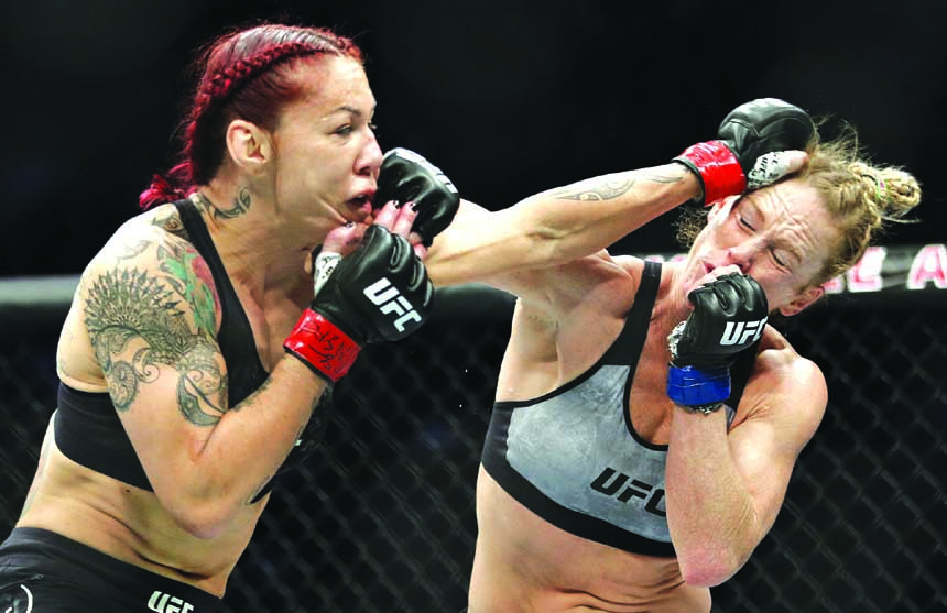 Holly Holm (right) and Cris Cyborg exchange blows during a featherweight championship mixed martial arts bout at UFC 219 in Las Vegas on Saturday.