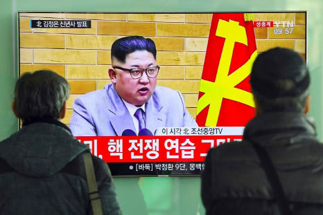 People watch a television news broadcast showing North Korean leader Kim Jong-Un's New Year's speech, at a railway station in Seoul on Monday.
