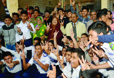 BOGRA: Students and teachers of Bogra Zilla School celebrating success in PSC and JSC examinations result by showing V-sign on Wednesday.