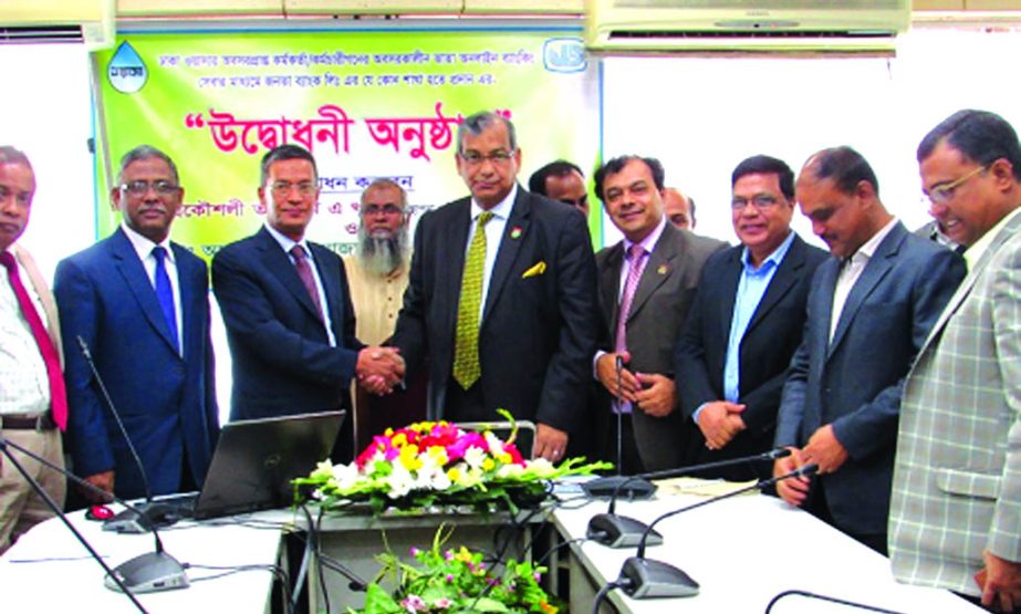 Engr. Taqsem A Khan, Managing Director of Dhaka WASA and Md. Abdus Salam Azad, Managing Director of Janata Bank Limited, shaking hands after inaugurating the online payment service to its pensioners at city's WASA Bhaban on Monday. Under the deal, all pe