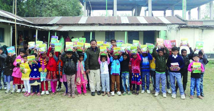 DUPCHANCHIA (Bogra): Principal of Dupchanchia Sammilito Pre-cadet School Emdadul Haque seen with students with text books on Monday.