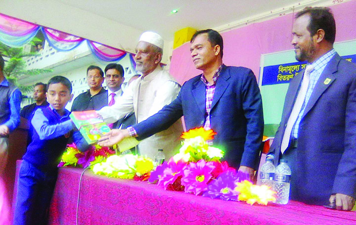 NARSINGDI: Zilla Parishad Chairman Abdul Matin Bhuiyan distributing new text books as Chief Guest at Satirpara KK Institute School and College on Monday.