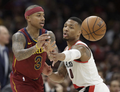 Cleveland Cavaliers' Isaiah Thomas (3) passes against Portland Trail Blazers' Damian Lillard (0) in the first half of an NBA basketball game in Cleveland on Tuesday.