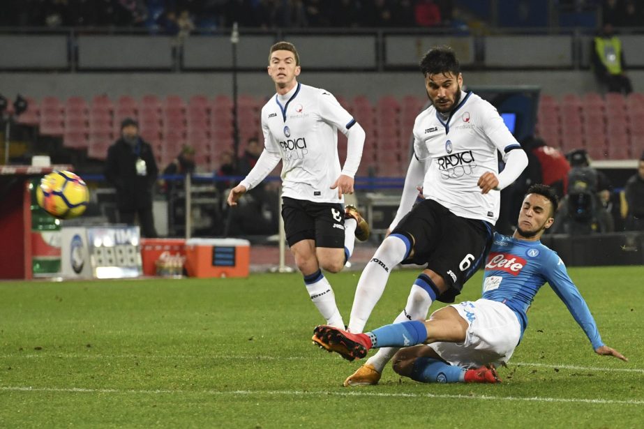 Napoli's Adam Ounas (bottom right) and Atalanta's Jose Luis Palomino vie for the ball during an Italy Cup quarter-final soccer match between Napoli and Atalanta, at the San Paolo stadium in Naples, Italy on Tuesday.