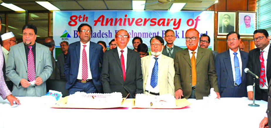 Manjur Ahmed, Managing Director of Bangladesh Development Bank Limited, celebrating its 8th anniversary at the banks conference room. DMD A.K.M. Hamidur Rahman and other officials of the bank were also present.