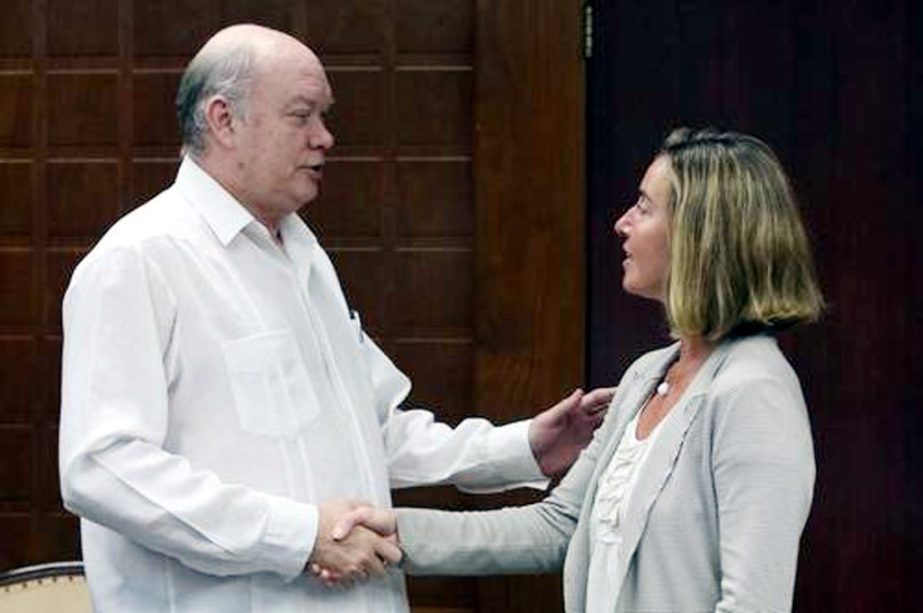 The European Union's foreign policy head, Federica Mogherini, shakes hands with Cuban Foreign Trade and Investment Minister Rodrigo Malmierca during a meeting in Havana, on Wednesday as part of her official visit to Cuba.