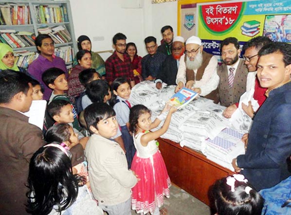 Chairman of Chittagong Shikkhak Kalyan Foundation Principal Dr.Abdul Karim distributing free text books to the students of different classes of Parents Care School and College at its Chowkbazar Campus recently.