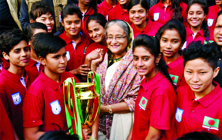 Prime Minister Sheikh Hasina with the members of Bangladesh Under-15 National Women's Football team pose for photograph at the Ganabhaban on Thursday. The team clinched the title of the SAFF Under-15 Women's Championship on 24th December.