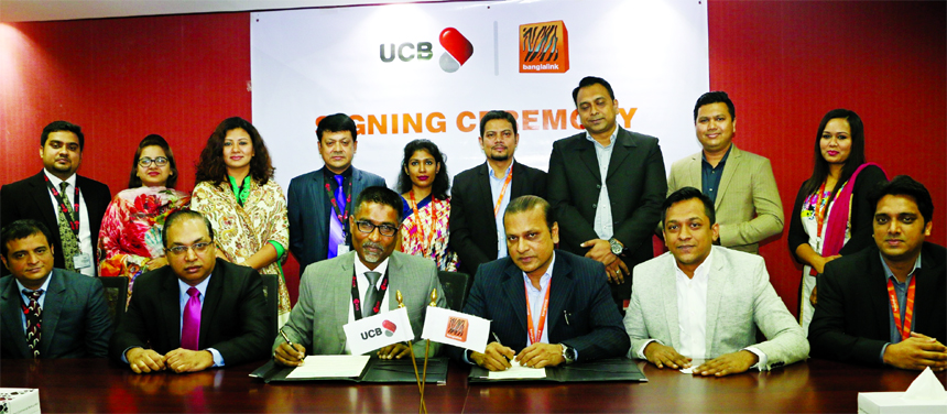 Taufiq Hassan, Head of Retail Business of UCB and KM Zakaria, Treasury Director (Finance) Banglalink, signing an agreement at bank's corporate office in the city recently. Under the deal, Credit Card holders of the bank will enjoy special discount and fa