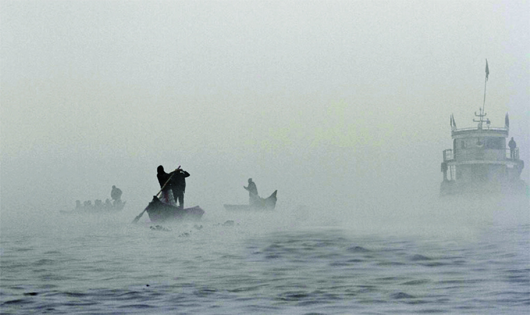 Navigation workers at Buriganga River taking risk of life and may face any accident to ply their transports due to heavy thick fog. This photo was taken from Sadarghat terminal on Friday.