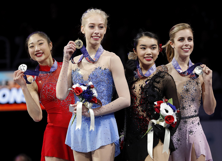 Bradie Tennell (foreground) poses after winning the women's free skate event with second place finisher Mirai Nagasu (left), third place finisher Karen Chen (second from right) and fourth place finisher Ashley Wagner at the U.S. Figure Skating Championsh