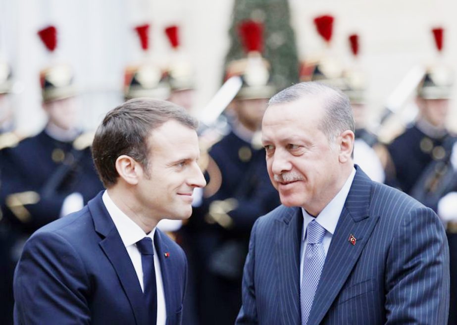 Turkish President Recep Tayyip Erdogan, right, is welcomed by French President Emmanuel Macron, at the Elysee Palace in Paris on Friday.