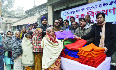 DINAJPUR: Food Traders Group distributing warm clothes among the cold-hit people at Dinajpur yesterday.