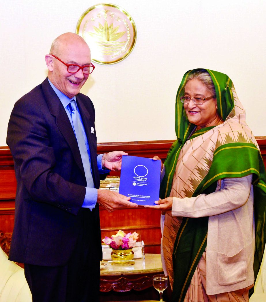 Former Director General of World Trade Organization (WTO) Mr. Pascal Lamy presenting a book to Prime Minister Sheikh Hasina at the latter's office on Sunday. BSS photo