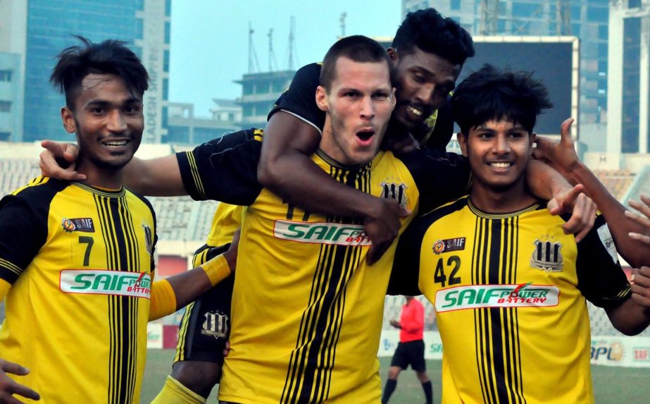 Players of Saif Sporting Club celebrating after defeating Chittagong Abahani Limited by three goals to nil in their match of the Saif Power Battery Bangladesh Premier League Football at the Bangabandhu National Stadium on Sunday.