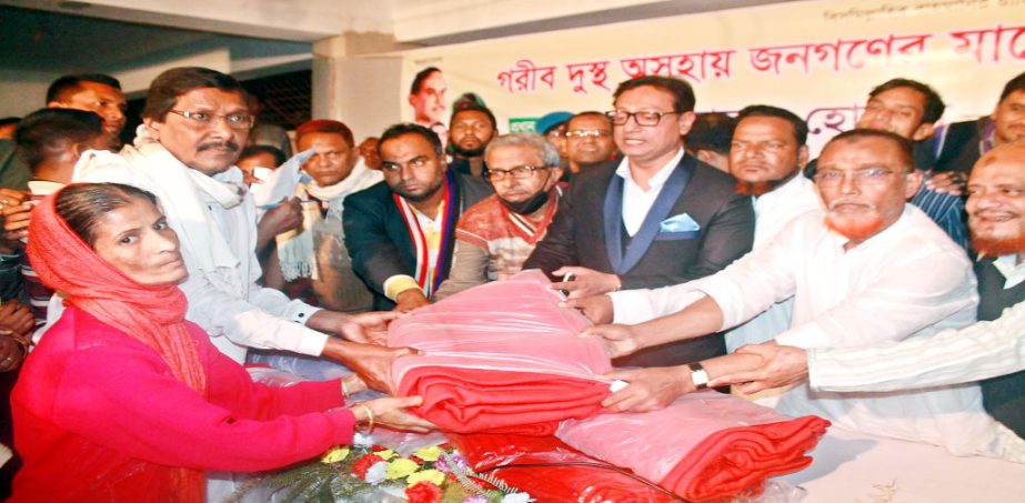 Chittagong City BNP President Dr Shahadat Hossain distributing warm clothes among the distressed people at Bakalia Ward in the city yesterday.