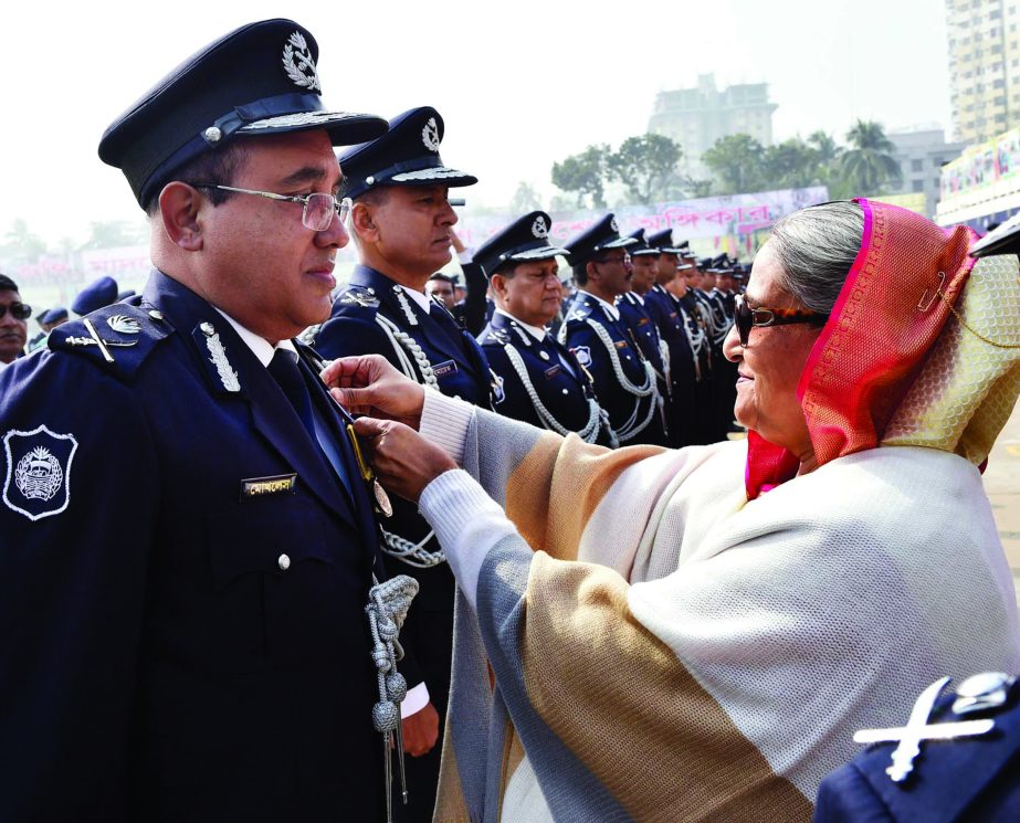 Prime Minister Sheikh Hasina adorns Additional IG (Admn Operation) Moklesur Rahman with PPM Medal at Rajarbag Parade Ground in the city on Monday marking Police Week-2018.