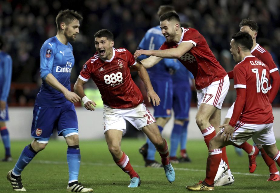 Nottingham Forest's Eric Lichaj (center) celebrates scoring his side's second goal of the game during the English FA Cup, Third Round soccer match between Nottingham Forest and Arsenal at the City Ground, Nottingham, England on Sunday.