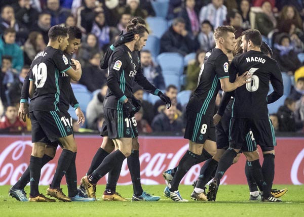 Real Madrid's Gareth Bale (center) is congratulated by teammates after scoring the second goal during a Spanish La Liga soccer match between RC Celta and Real Madrid at the Balaidos stadium in Vigo, Spain on Sunday.