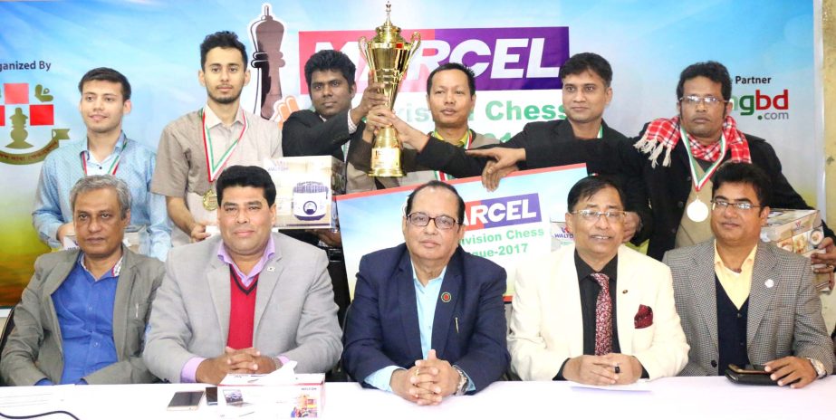 Prize winners of the Marcel 1st Division Chess League pose for photo with the trophy and guests at Bangladesh Chess Federation hall-room on Monday.