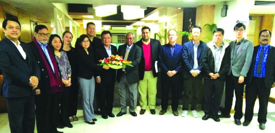 Syed Moazzam Hossain, President of Bangladesh-Malaysia Chamber of Commerce and Industry (BMCCI), presenting the bouquet to Malaysian Delegation leader Dato' Tan Seng Sung of TC Management Service Corporation at BMCCI Office in the city on Monday. Senior