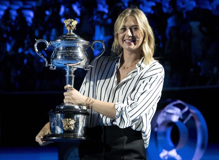 Former ladies single's champion Russia's Maria Sharapova poses for a photo with the Daphne Akhurst Memorial Cup on Margaret Court Arena during the ceremony for the official draw at the Australian Open tennis championships in Melbourne, Australia on Thur