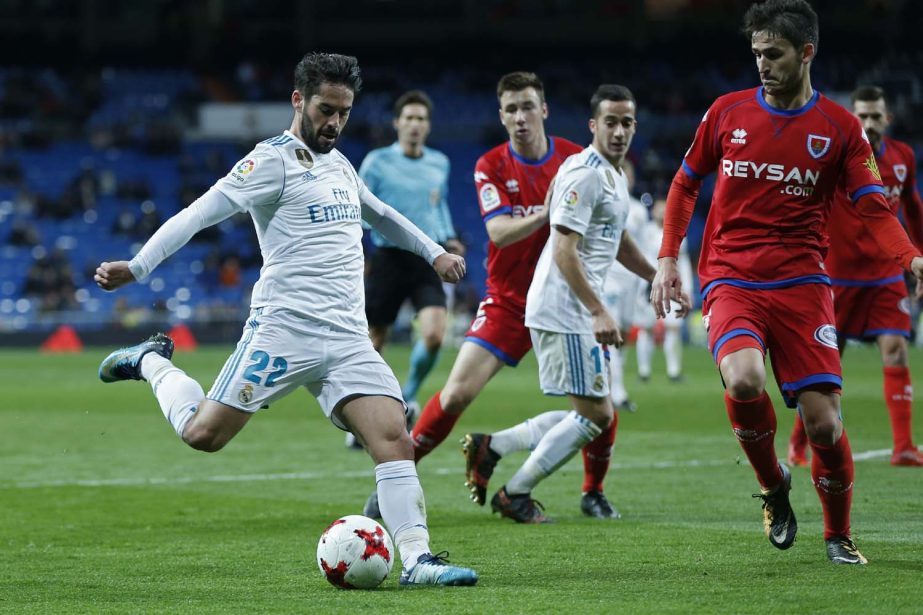 Real Madrid's Francisco Roman "Isco"" (left) shoots the ball next to Numancia's Unai Elgezabal during the Spanish Copa del Rey round of 16 second leg soccer match between Real Madrid and Numancia at the Santiago Bernabeu stadium in Madrid on Wednesday."