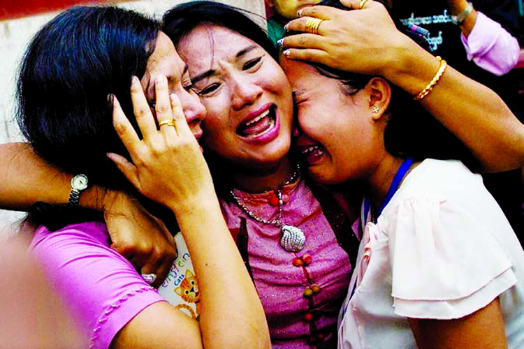 Family members of Kyaw Soe Oo outside the court in Yangon are wailing after hearing the news of charge.