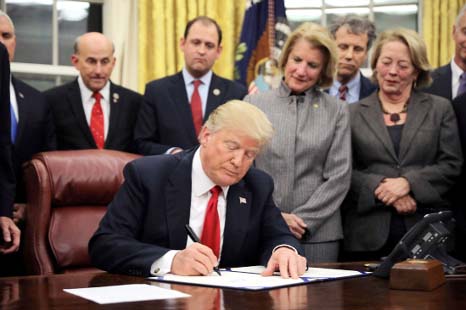 US President Donald Trump signs the Interdict Act into law, to provide Customs and Border Protection agents with the latest screening technology on the fight against the opioid crisis, in the Oval Office of the White House in Washington D.C., on Wednesday