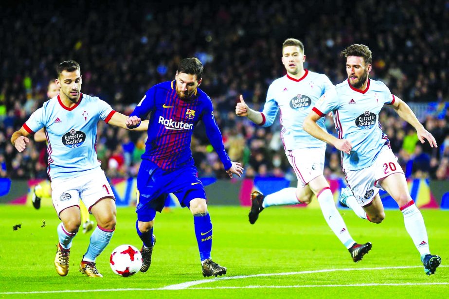 FC Barcelona's Lionel Messi (second left) duels for the ball against Celta de Vigo's Jonny Castro (left) during the Spanish Copa del Rey round of 16 second leg soccer match between FC Barcelona and Celta de Vigo at the Camp Nou stadium in Barcelona, Spa